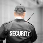 Security guard holding a walkie-talkie.
