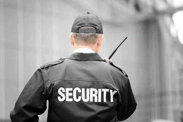 782064622 Security guard holding a walkie-talkie.