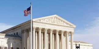 United States Supreme Court building with American flag.