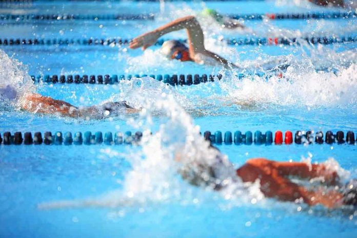 Swimmers competing in a pool, creating splashes of water