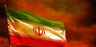 Iranian flag waving against a dramatic orange sky