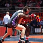 TRANS Accused of GROTESQUE Behavior During Wrestling Match Two wrestlers competing on a mat during a match