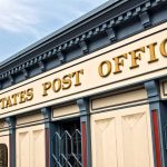 Exterior view of a United States Post Office building with a prominent sign