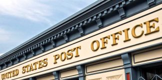 Exterior view of a United States Post Office building with a prominent sign