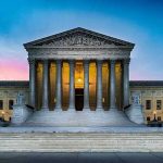 Supreme Court GREENLIGHTS Bans — 21 States NOT BUDGING Supreme Court building with illuminated pillars and steps.
