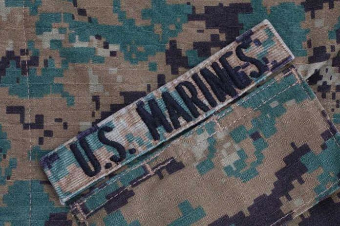 2184490991 US Marines patch on camouflage uniform fabric