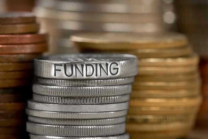 784896787-1 Stack of coins labeled funding with other coins stacks
