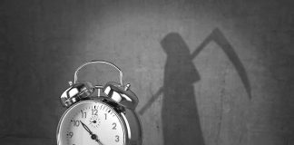 alarm clock with grim reaper shadow