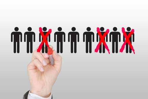 A hand using a red marker to cross out human figures in a selection process