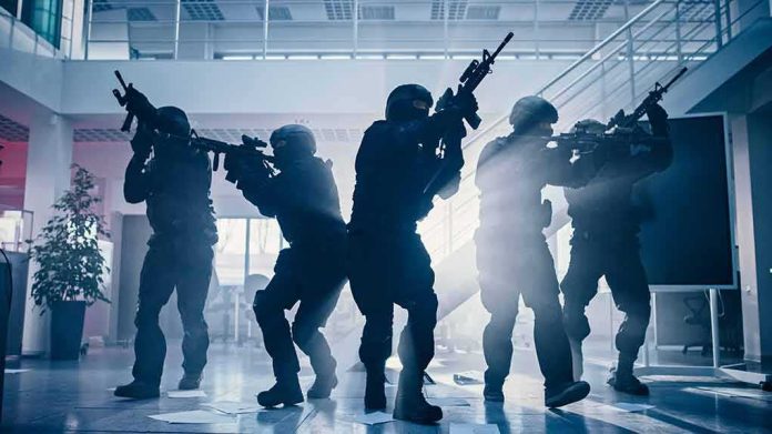 Tactical police team advances through a smoky office building
