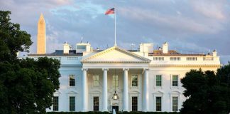 The White House with Washington Monument in background.
