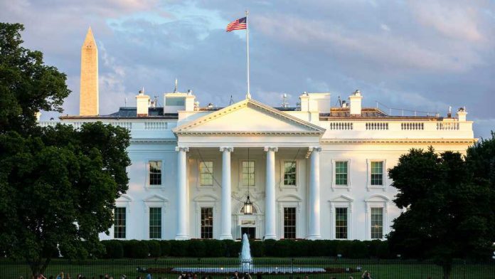 The White House with Washington Monument in background.