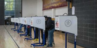 Prison Warnings LOOM Over ELECTION ROLLS! Voters at polling booths in a gymnasium