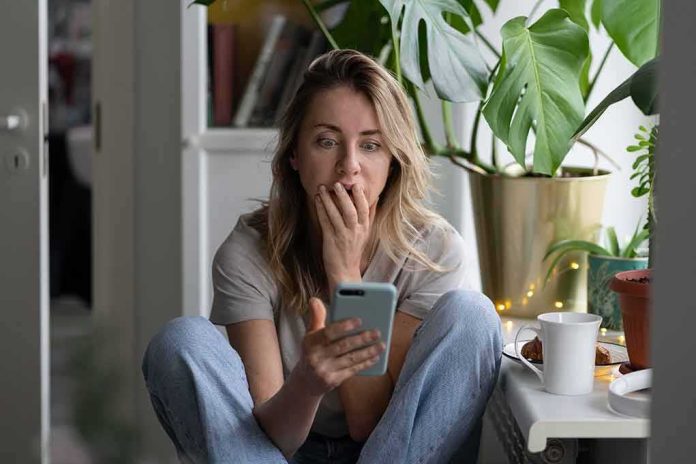 Woman sitting by plants looking at smartphone with surprised expression