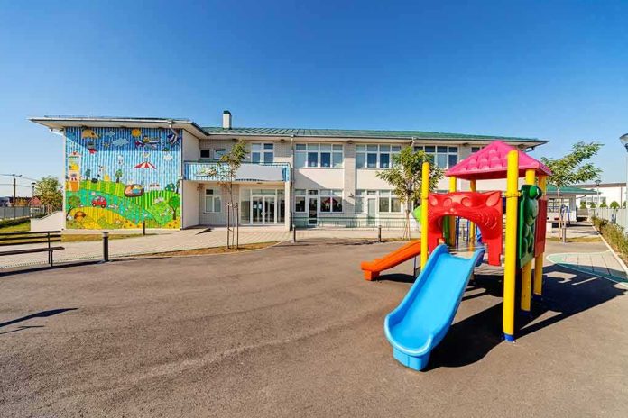 Playground with colorful slide in front of a school building
