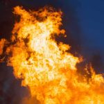 Large flames against a dark blue sky