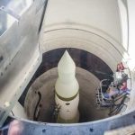 View of a missile inside a silo with maintenance equipment