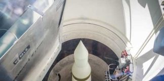 View of a missile inside a silo with maintenance equipment