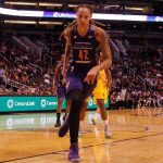 basketball player dribbling on a court during a game