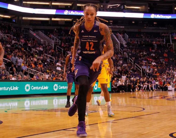 basketball player dribbling on a court during a game