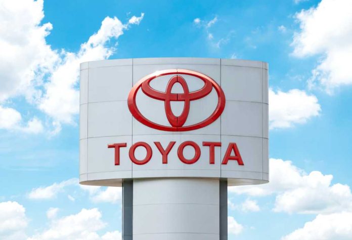 Toyota dealership sign with red logo against blue sky