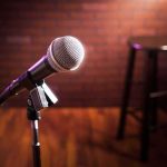 Microphone on stand with stool in blurred background