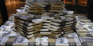 Stacks of U.S. hundred-dollar bills arranged in a pyramid