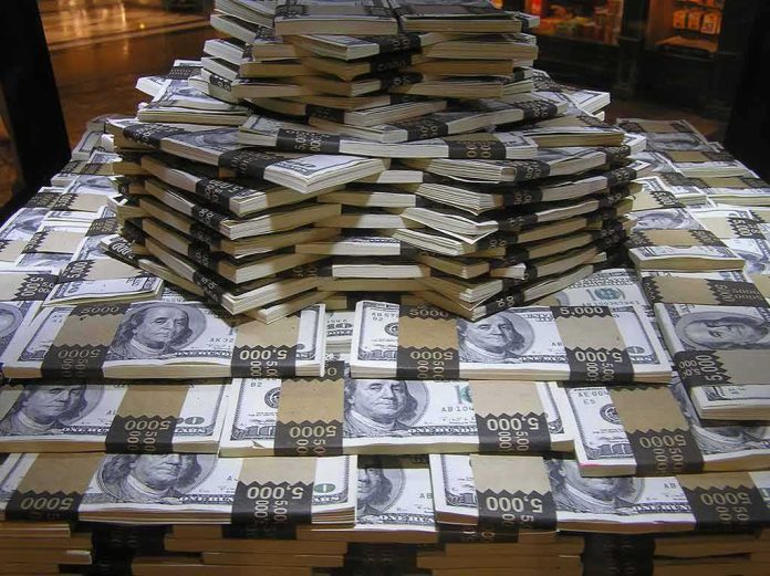 Stacks of U.S. hundred-dollar bills arranged in a pyramid