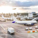 TERRIFYING — Explosive Drone DISCOVERED At Major Hub Airplanes at airport gates during sunset with ground vehicles and jet bridges