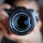camera lens close-up held by a person