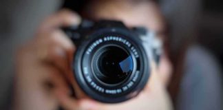 camera lens close-up held by a person