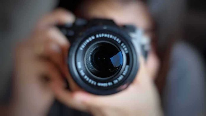 camera lens close-up held by a person
