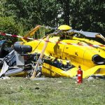 yellow helicopter crash scene on grassy field