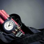 Time bomb with clock and dynamite sticks in a black bag