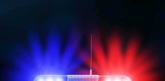 Police car roof with flashing red and blue lights at night