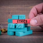 Ethics BOMBSHELL Topples House Republican — SCANDAL EXCALATES Hand holding a red block labeled ethics above teal blocks