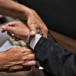 SHOCKING — Congressional Candidate ARRESTED! hands placing handcuffs on a suited person's wrists