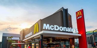 McDonald's restaurant exterior with drive-thru at sunset
