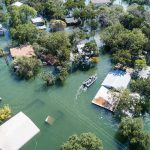 Night Of Rain, Cities Drowned — ALARMS Hit Level 5! Aerial view of flooded neighborhood with rescue boat navigating streets