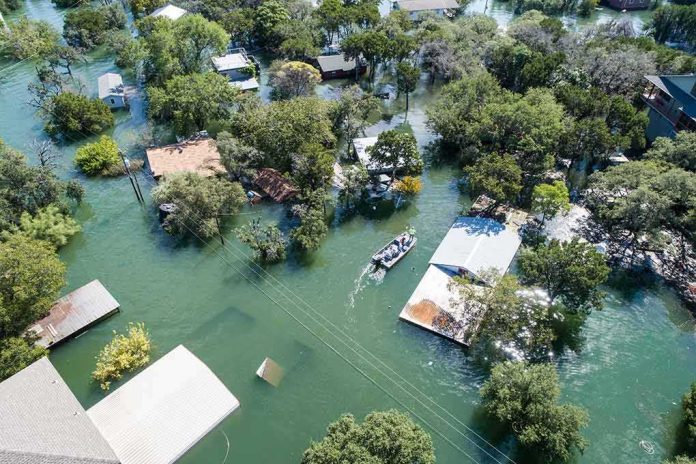Aerial view of flooded neighborhood with rescue boat navigating streets