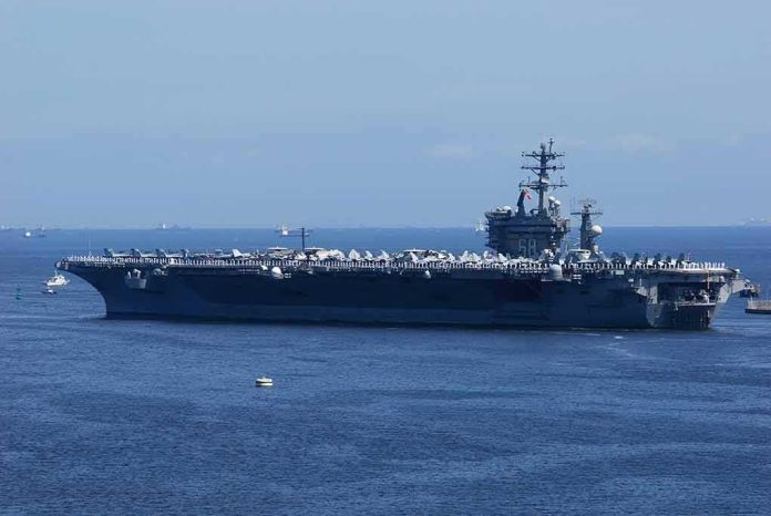 Aircraft carrier at sea with crew lining the deck