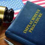 Impeachment procedure book with gavel and U.S. flag