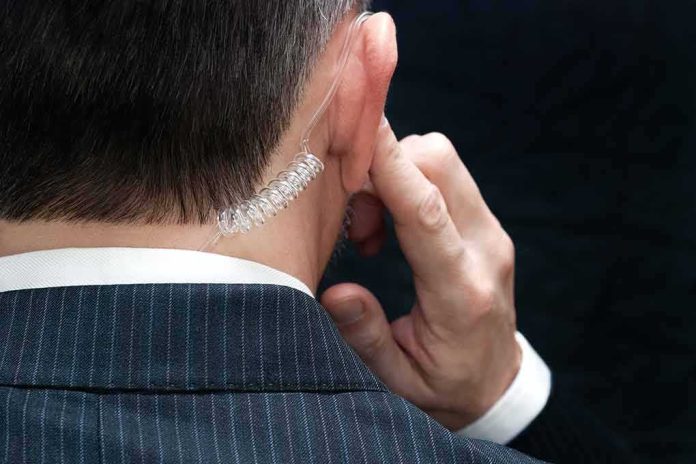security agent with earpiece touching ear