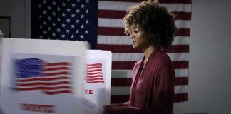 DA Drops Hammer — Candidate CHARGED WITH 5 FELONIES Voter at a polling booth with an American flag backdrop