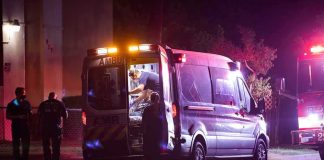 Ambulance at night with paramedics attending a patient