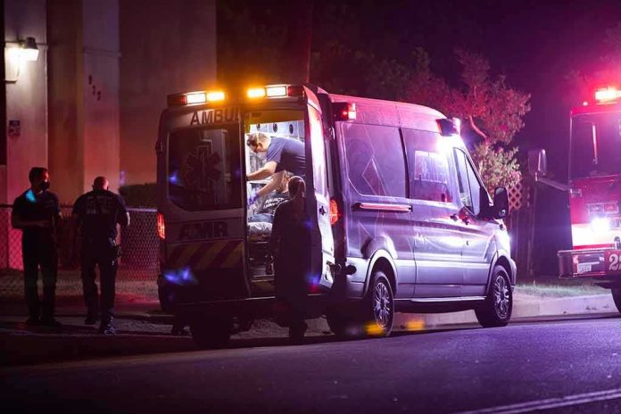 shutterstock_1842250744 Ambulance at night with paramedics attending a patient