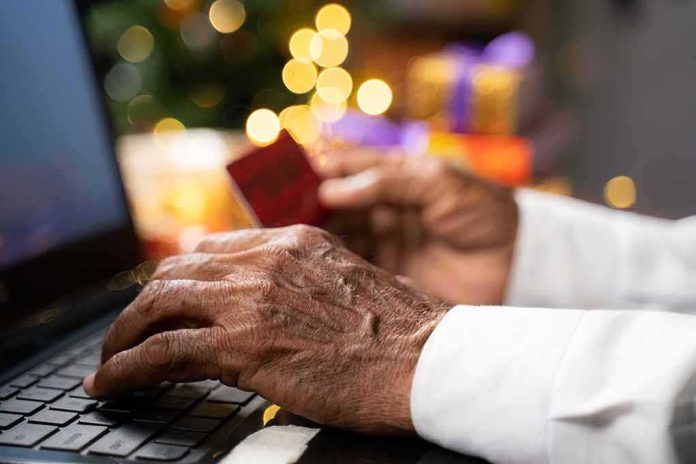 Hands using a laptop and holding a credit card