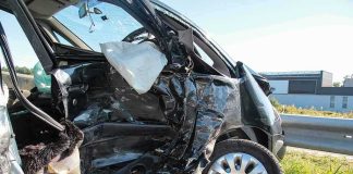 Crashed car with severe side damage and deployed airbag