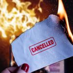 Burning paper stamped cancelled held by hand