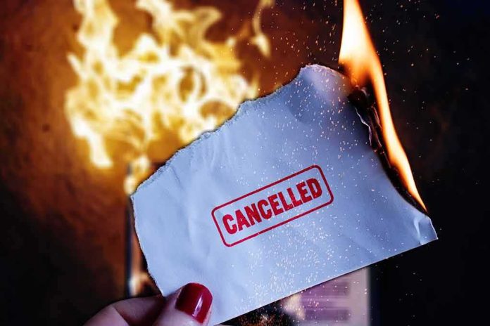 Burning paper stamped cancelled held by hand